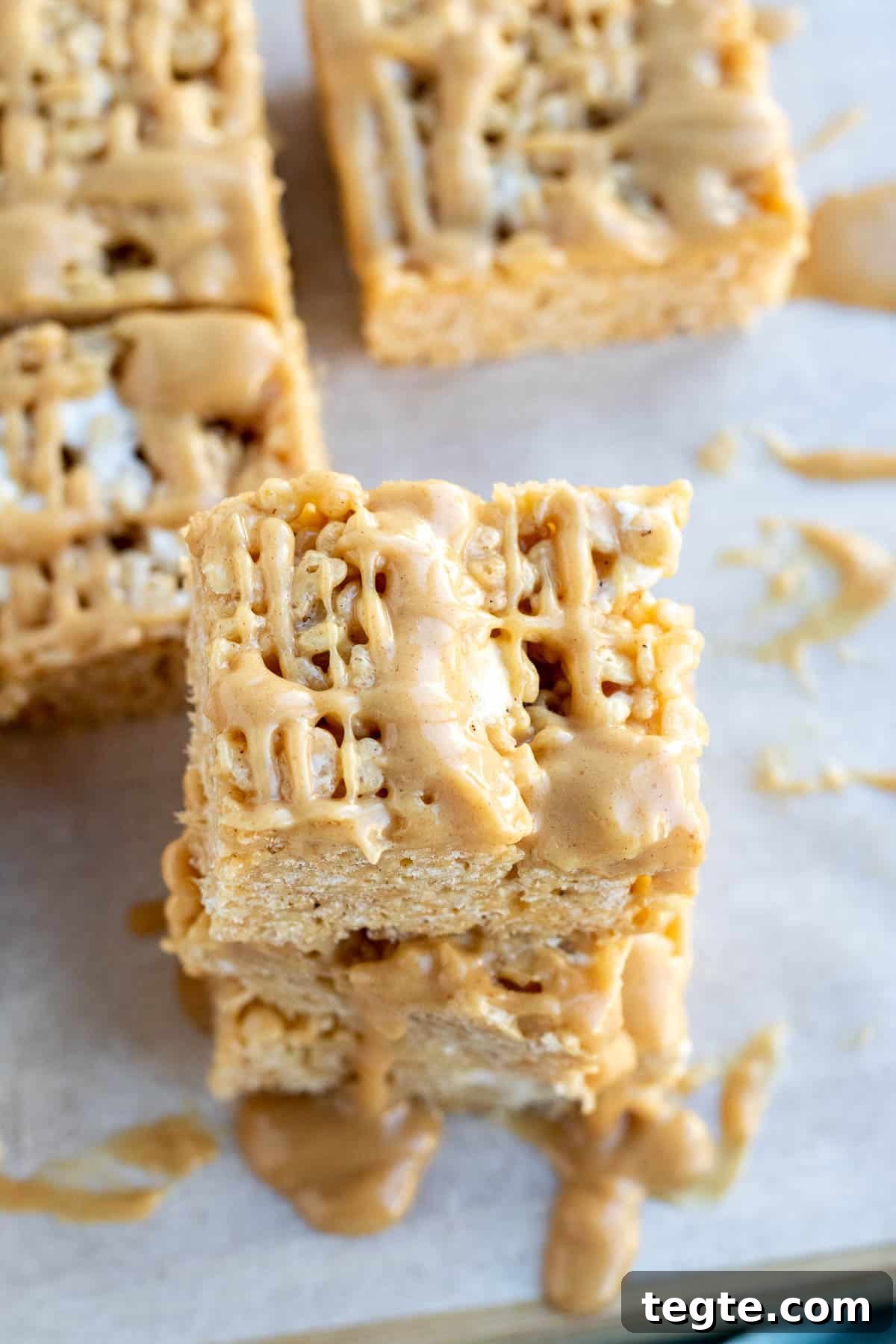 Peanut Butter Rice Krispie Bars Recipe — Crispy No-Bake Treat 5 close up of a peanut butter rice krispie bar with a peanut butter drizzle