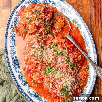 A blue and white platter serving chicken cacciatore.