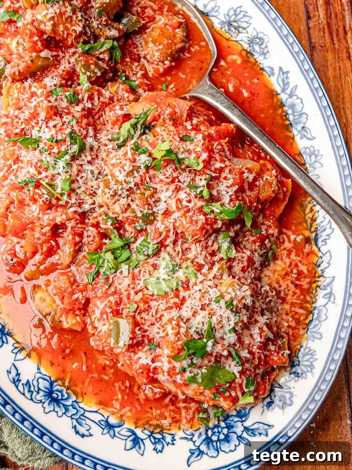 Chicken thighs topped with tomato sauce and parmesan cheese.