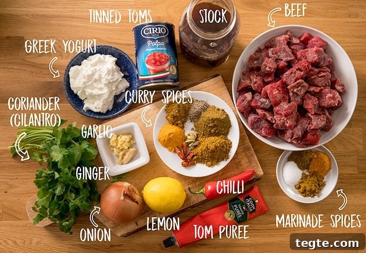Ingredients for slow cooked lighter beef curry on a wooden table