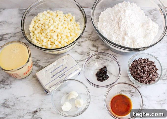 ingredients in glass bowls on a marble surface for red velvet fudge