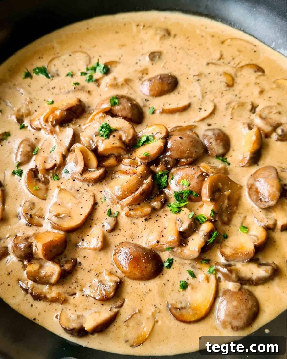 Rich and Velvety Mushroom Sauce Recipe for Pasta and Steak 6 Close up of mushroom in creamy sauce in a black pan