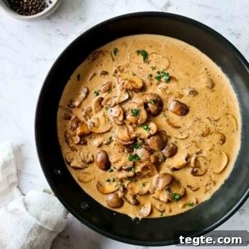 Creamy mushroom sauce in a black pan