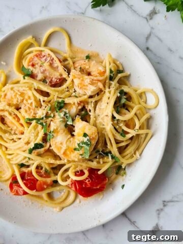 full plate of creamy garlic prawn pasta