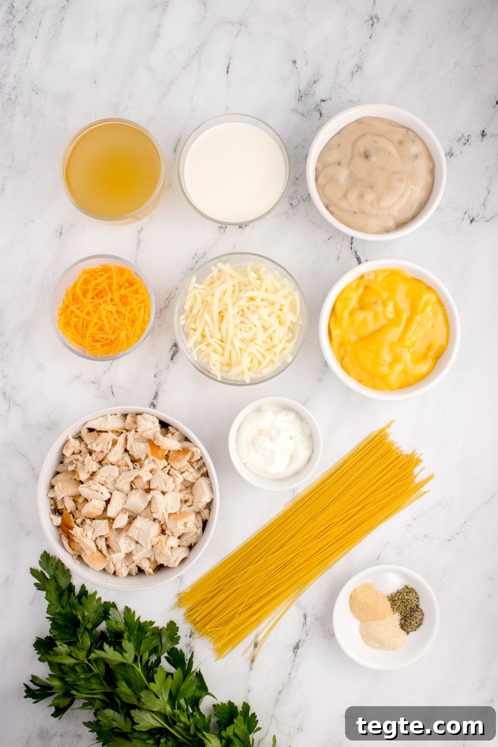 ingredients for chicken tetrazzini in single serve bowls on table 