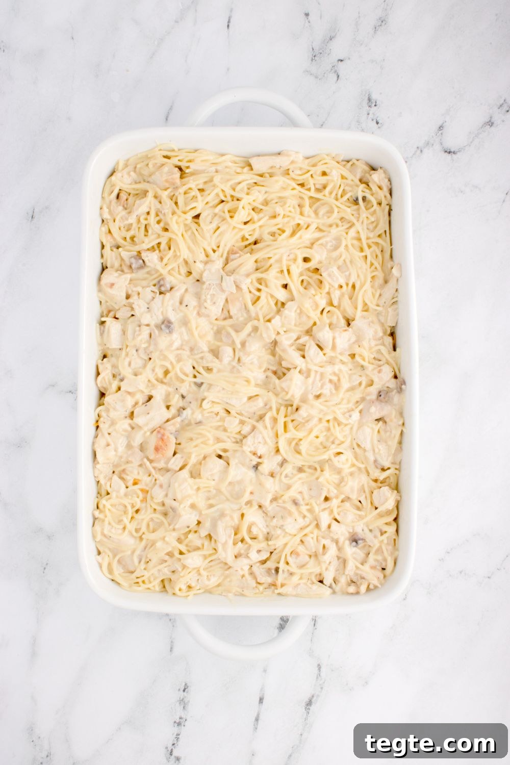 uncooked chicken tetrazzini in pan