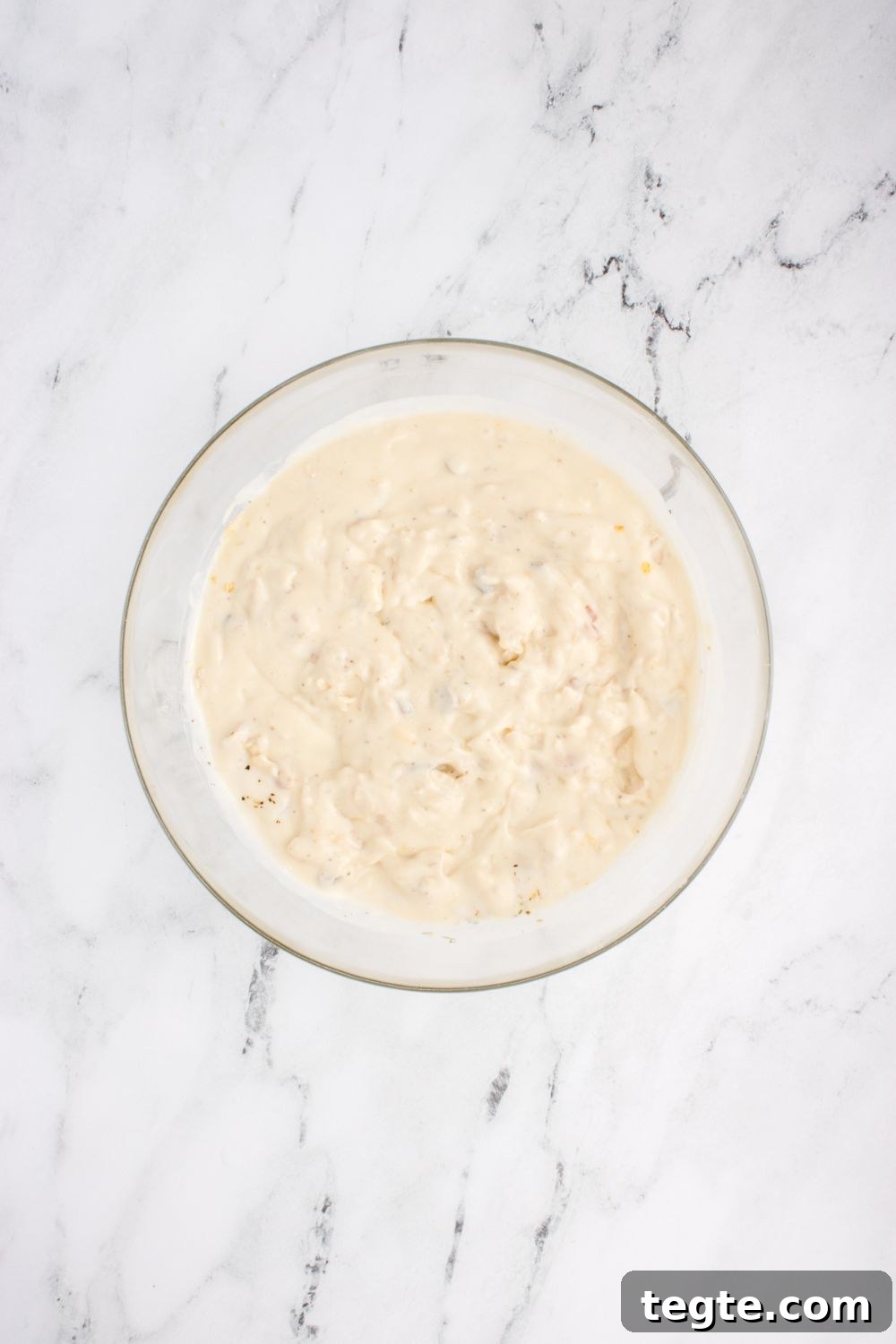 cream sauce mixed up in bowl on table for chicken tetrazzini