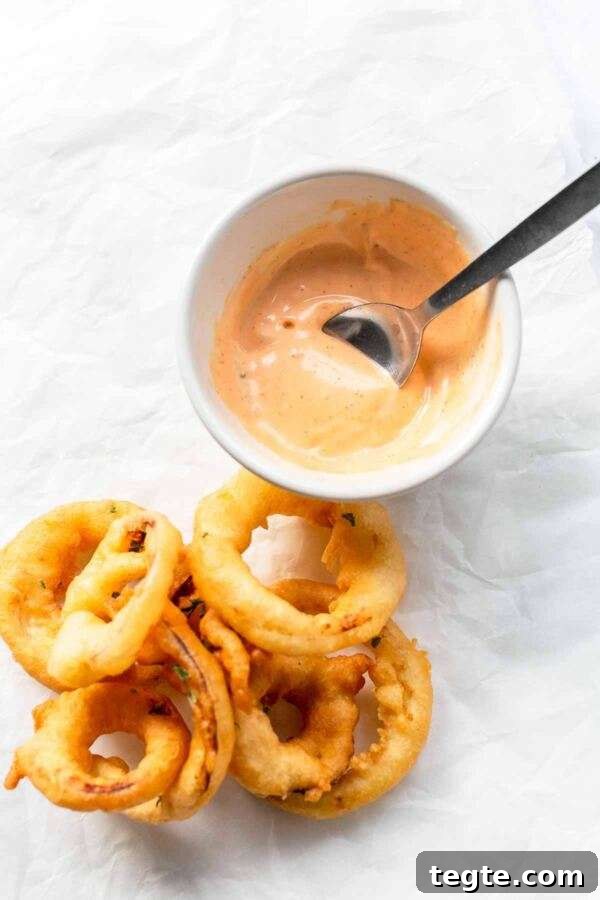 Creamy Spicy Mayo Recipe: Quick Homemade Sriracha Aioli 6 A white bowl with homemade spicy mayo and a spoon? You can easily make it your own.