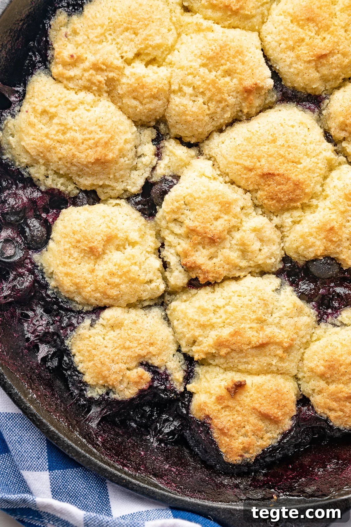Low-Carb Blueberry Cobbler (Gluten-Free, Sticky Sweet) 2 A baked low carb blueberry cobbler with golden mounds of baked cobbler topping.