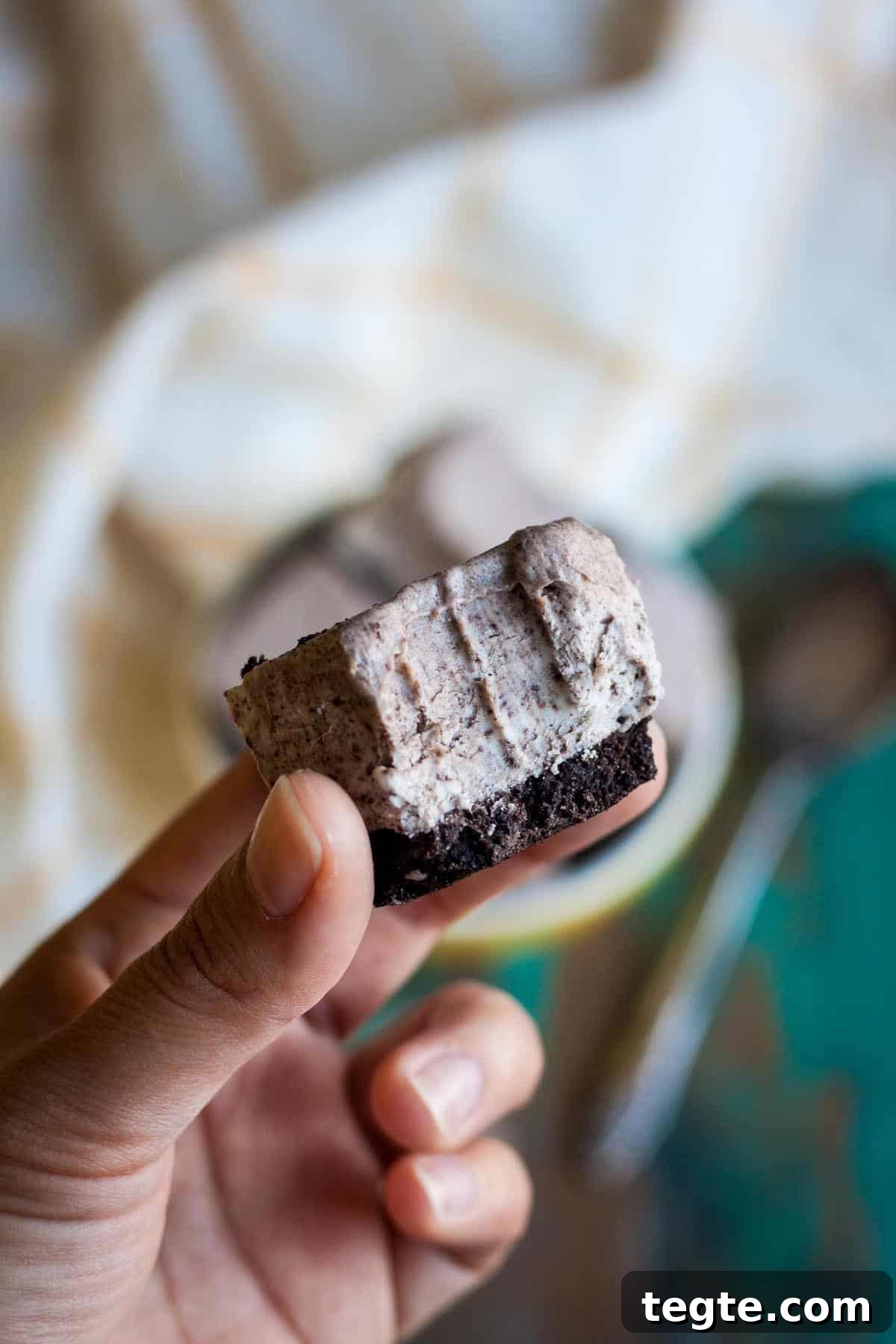 A piece of Oreo cheesecake bite being eaten. A piece of Oreo cheesecake bite being eaten.