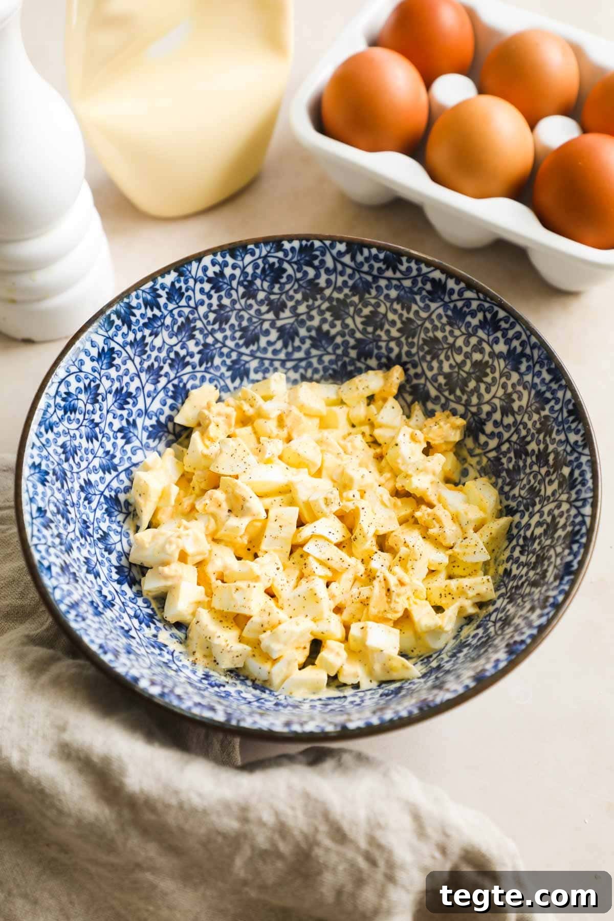 Classic Creamy Egg Salad Recipe — Fast Homemade Sandwich Filling 2 Easy and simple classic egg salad made with Kewpie mayo, salt, pepper, and chopped hard-boiled eggs in a bowl.