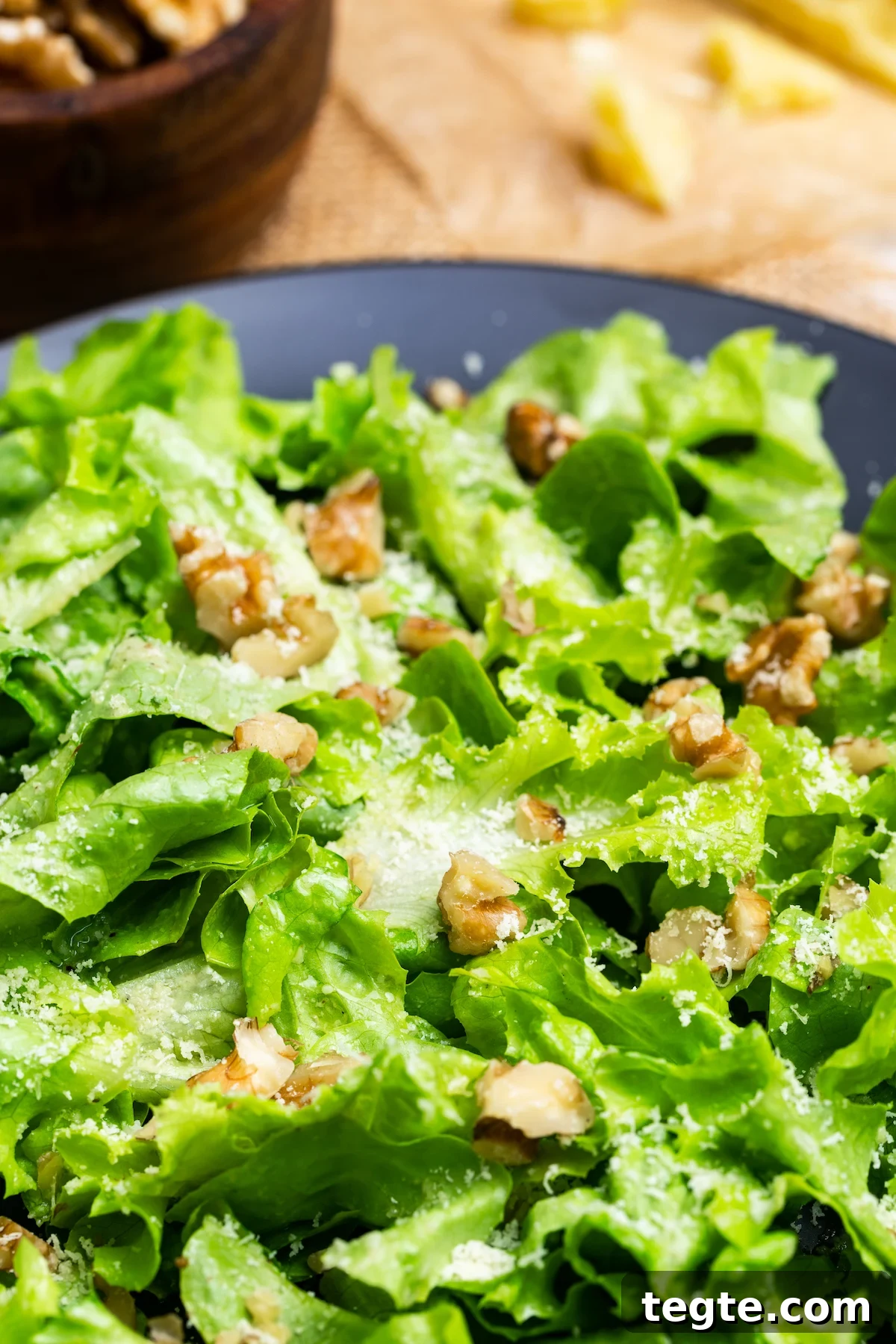 Bibb Lettuce Salad served on a black plate and photographed at an angle.