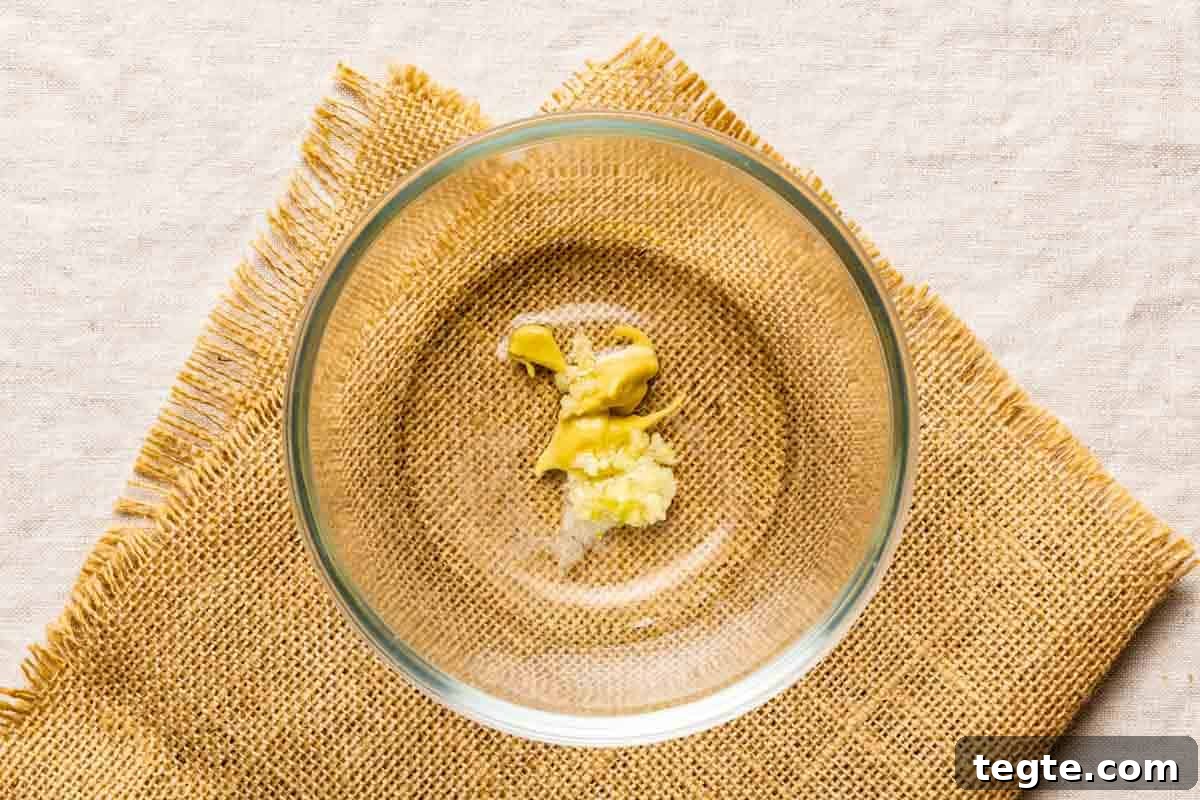 DIjon mustard and shallot in a glass bowl.