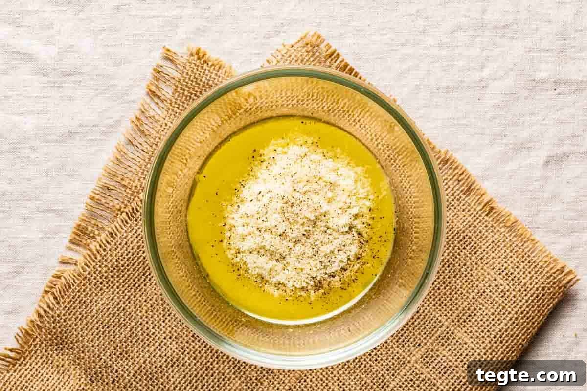 adding grated parmesan to vinaigrette.