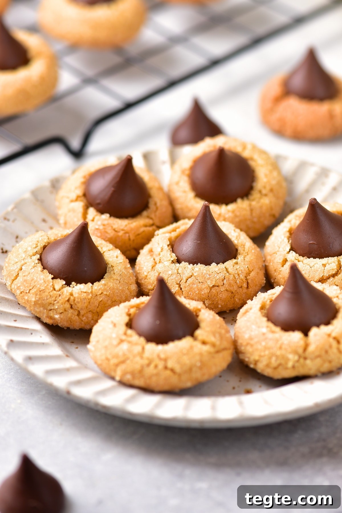 Gluten-free peanut butter blossoms on white plate.