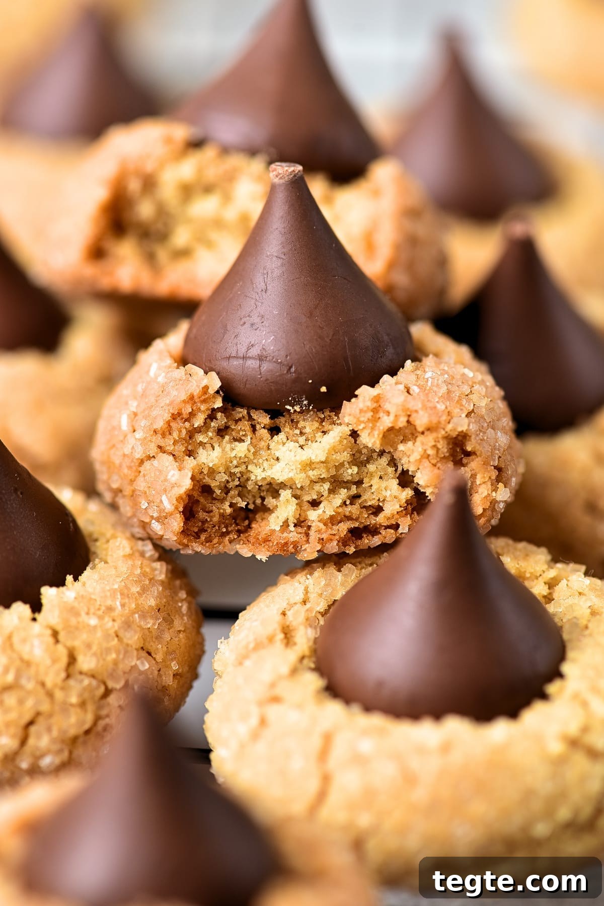 Up close shot of gluten-free peanut butter blossom cookies on wire rack.