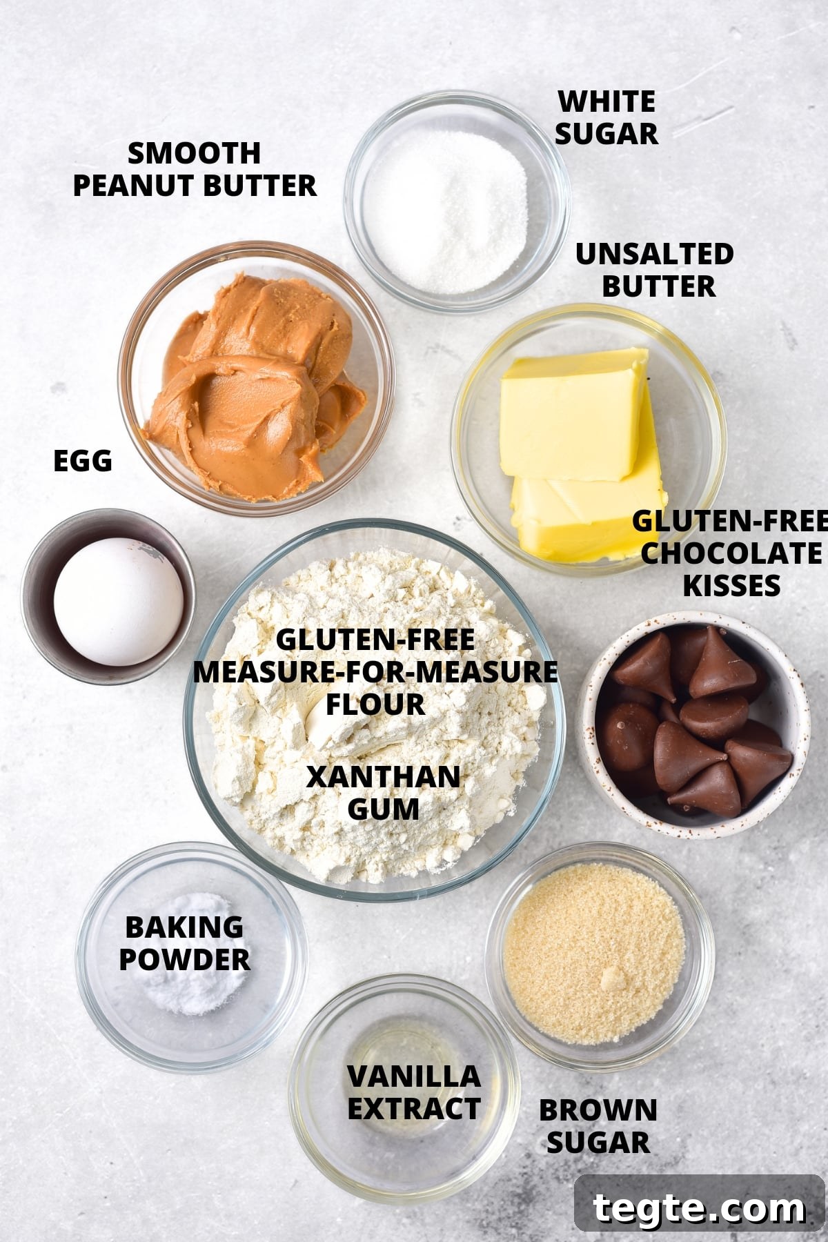 Ingredients for gluten-free peanut butter blossoms recipe laid out on board.