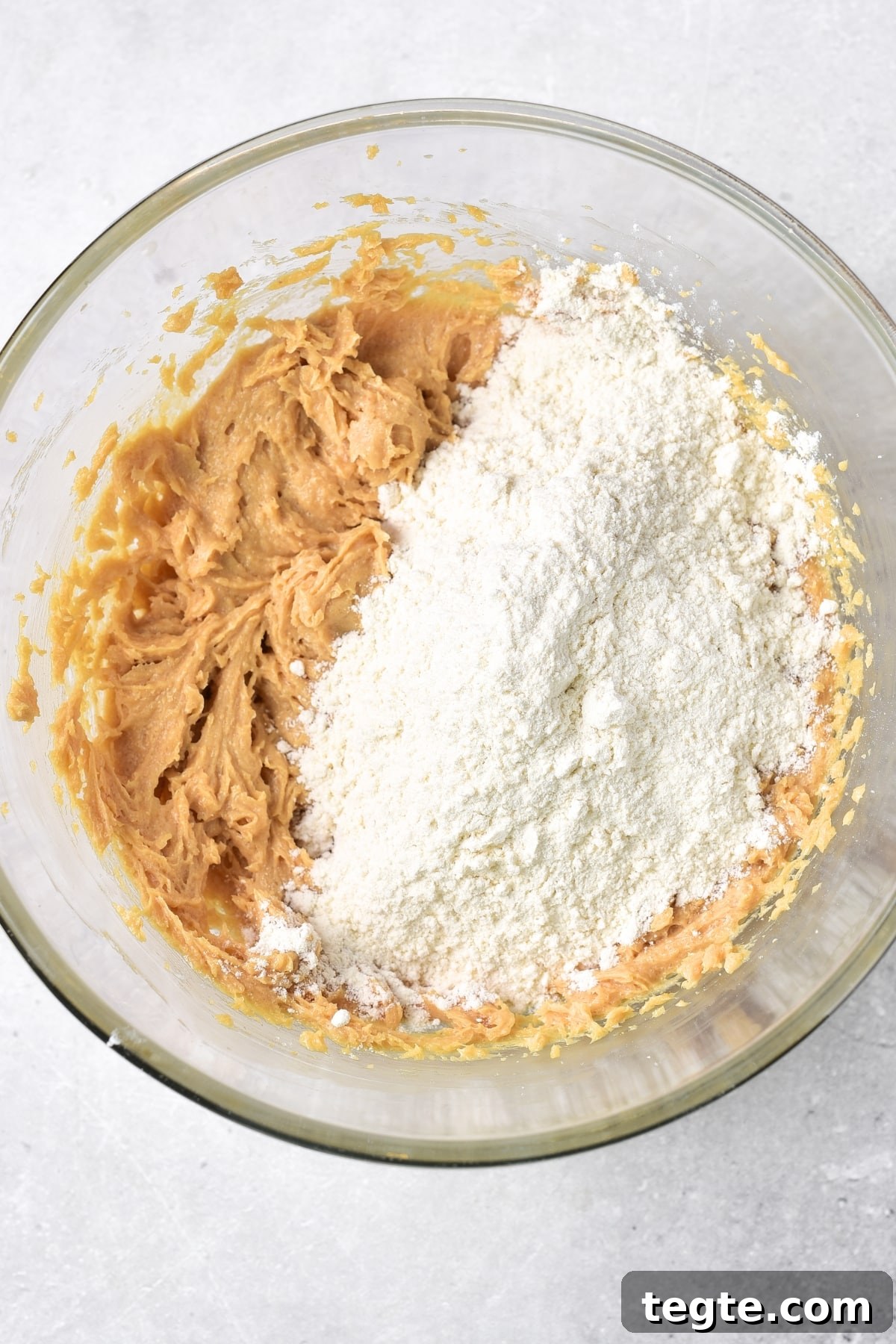 A bowl with peanut butter mixture and flour.