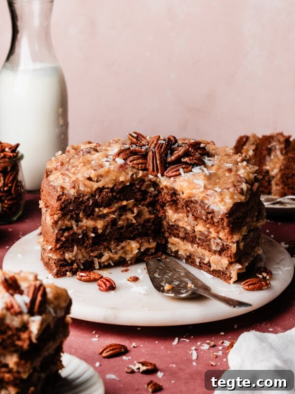 Eggless Chocolate Cake with Decadent Chocolate Fudge Frosting 13 The sliced german chocolate cake on a marble cake plate.