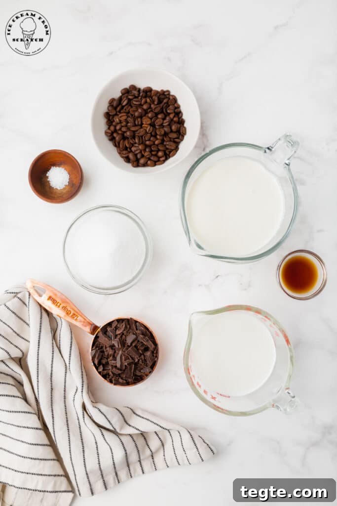 ingredients needed for java chip ice cream, each in separate dishes on a marble countertop with a black and white striped tea towel.