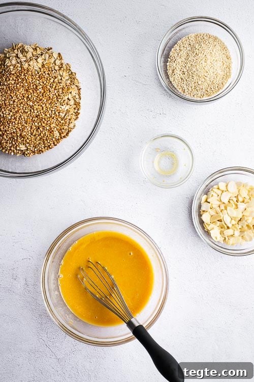 A top down view of the ingredients for tahini granola with orange and honey.