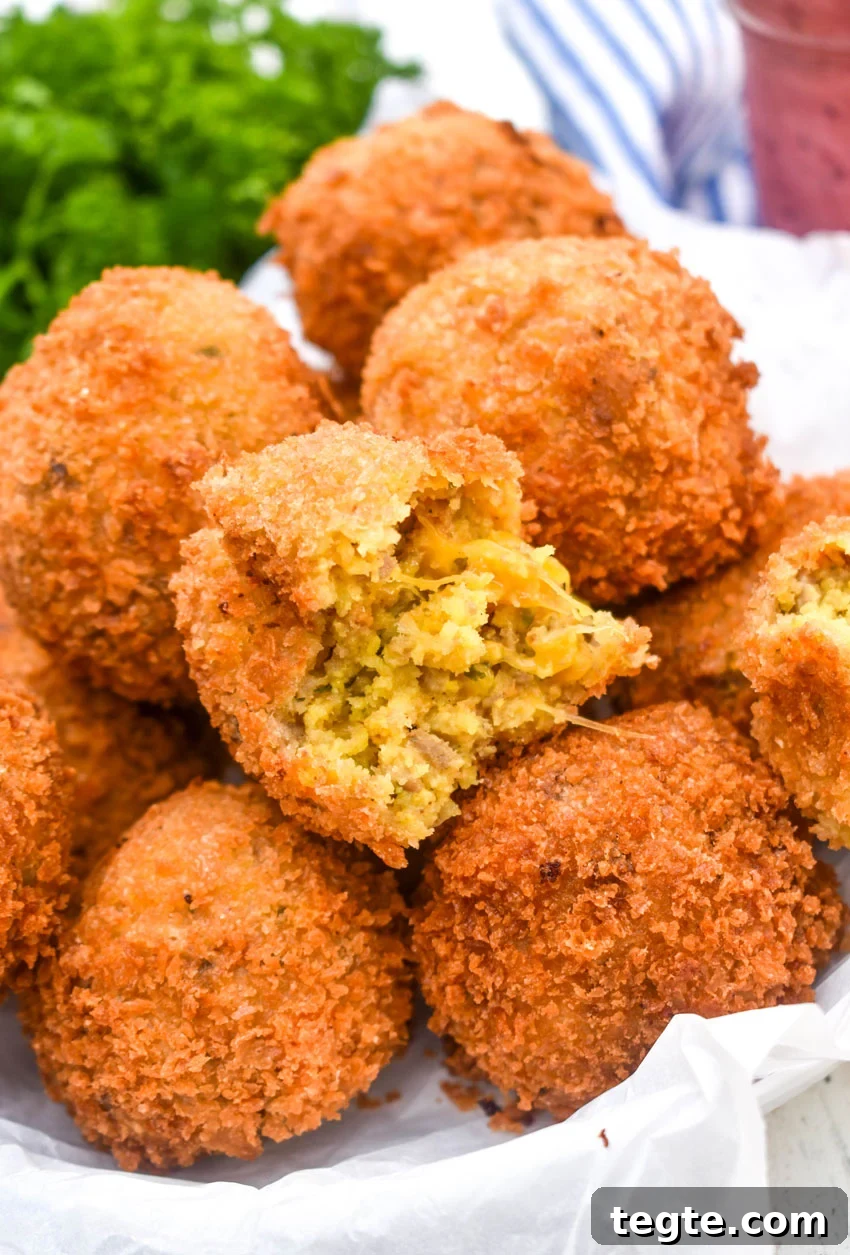 Cornbread Dressing Fritters Recipe: Crispy Southern Side Dish 2 a pile of crispy cornbread dressing fritters on a parchment paper lined bowl