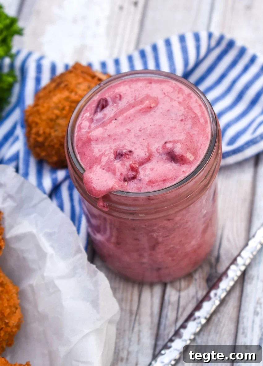 Cornbread Dressing Fritters Recipe: Crispy Southern Side Dish 5 creamy cranberry dipping sauce in a small glass mason jar