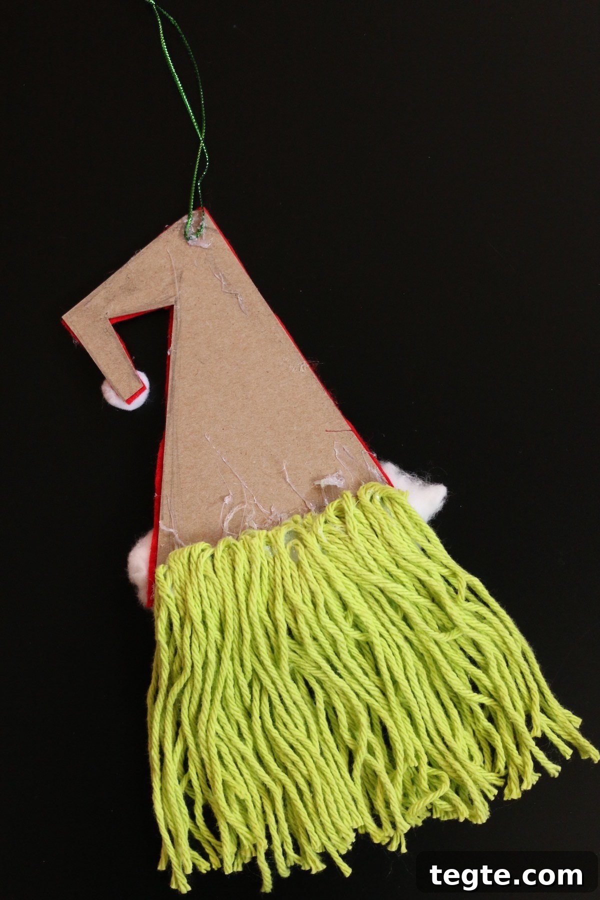 green yarn glued to back side of cardboard hat