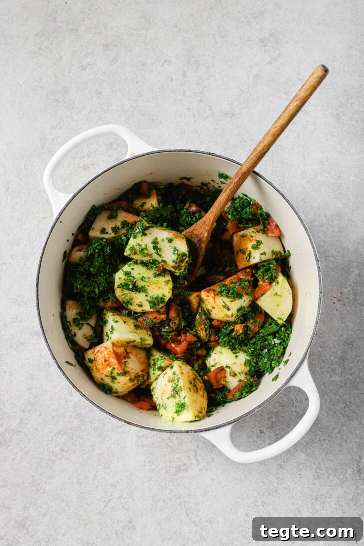 Aloo methi ingredients in a dutch oven ready to be cooked