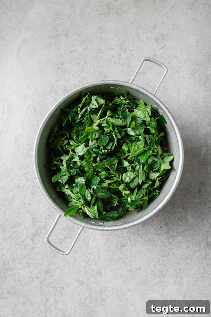 Draining soaked fenugreek leave in a colander