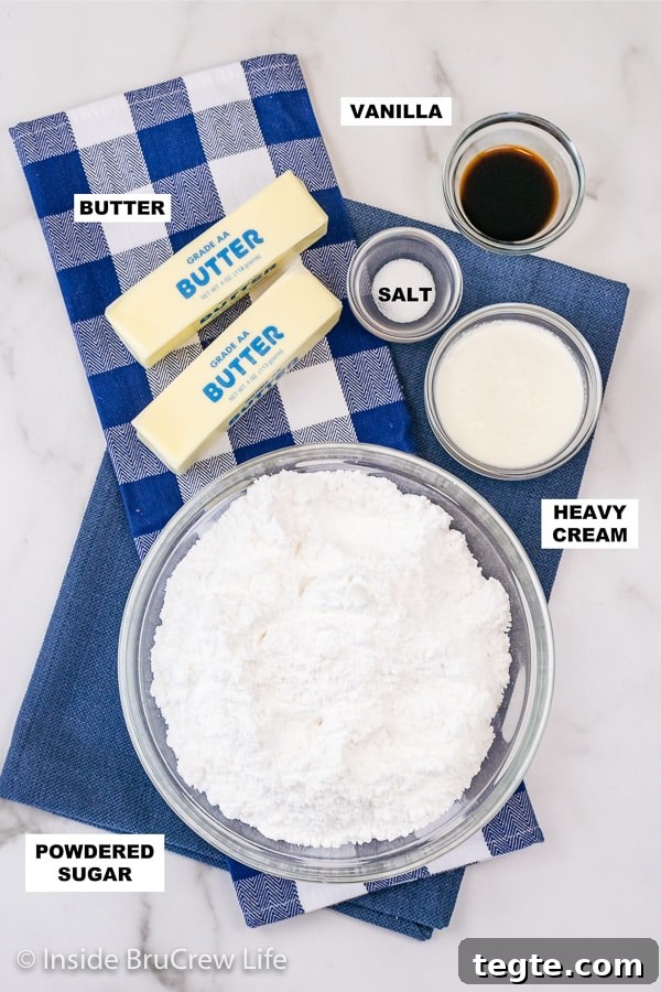 Overhead picture of a white board with bowls of ingredients needed to make vanilla buttercream frosting.