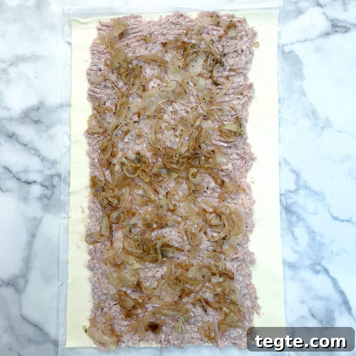Savory Sausage and Caramelized Onion Pinwheel Appetizers 8 Caramelised onions spread onto the sausage meat.