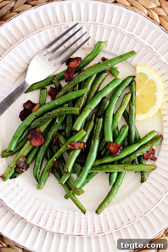Sautéed Green Beans with Bacon — Quick Skillet Recipe (Video) 7 Sautéed Green Beans with bacon and lemon on a plate