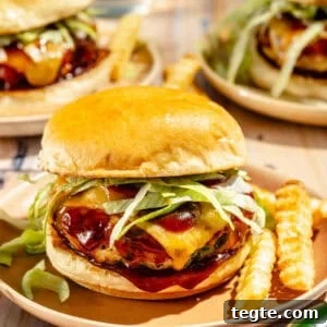 up-close shot of jalapeño cheddar turkey burgers on a plate with french fries
