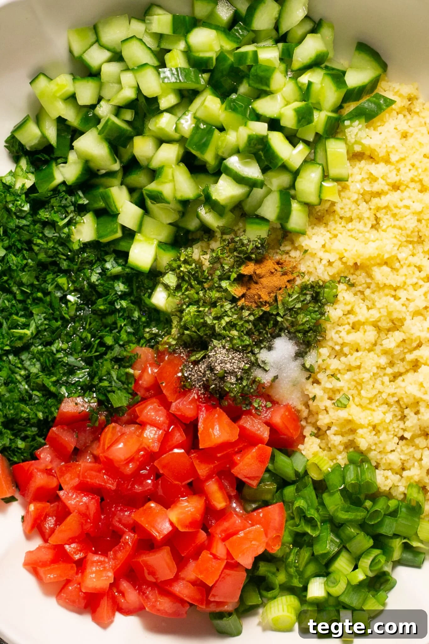fresh ingredients for bulgur salad in a mixing bowl.