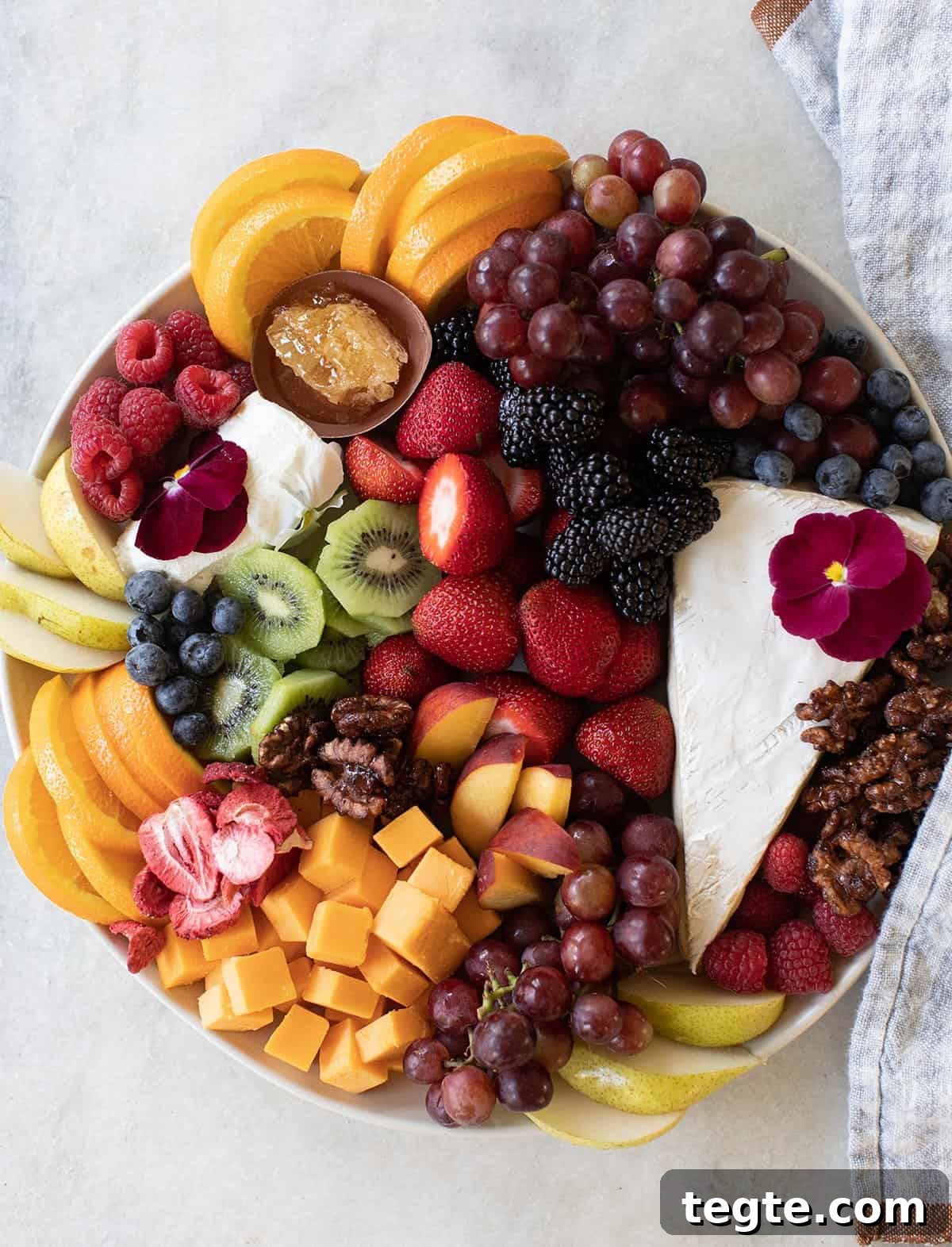 Strawberry Dessert Ideas for Entertaining Guests 11 Fruit and cheese platter with fresh strawberries, kiwi, oranges, and more fruit.
