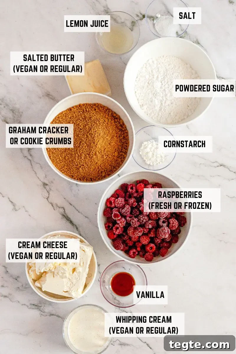 Gluten-Free Vegan Raspberry Cheesecake Recipe 4 A white and light pink raspberry no-bake cheesecake topped with bright red raspberry sauce and a border of bright white whipped cream. There are fresh red raspberries on the whipped cream and a few green raspberry leaves.