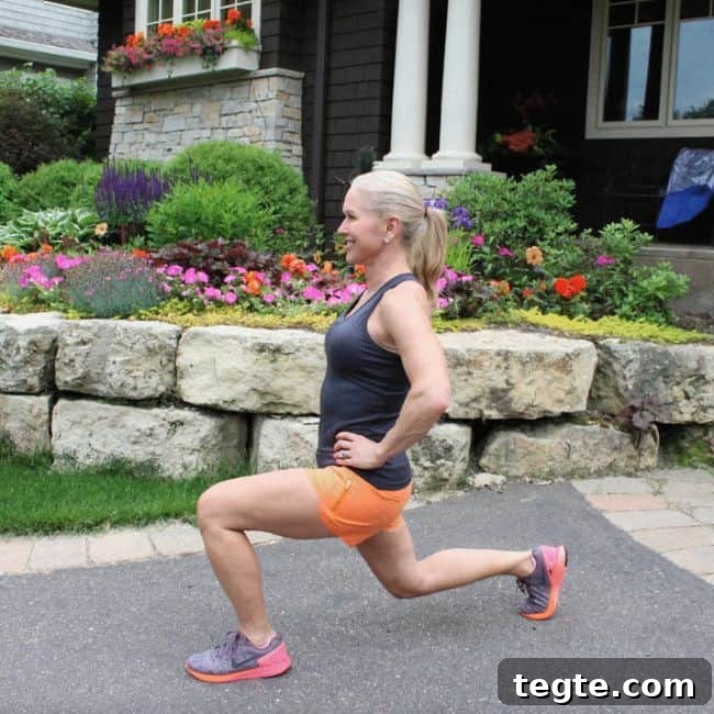 Outdoor Driveway Cardio and Strength Circuit for Women 4 Woman performing a lunge exercise outdoors.