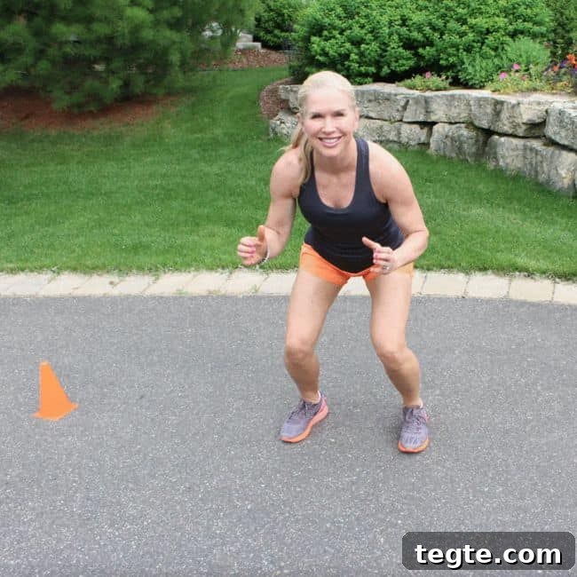 Outdoor Driveway Cardio and Strength Circuit for Women 7 Person performing a squat exercise on pavement.