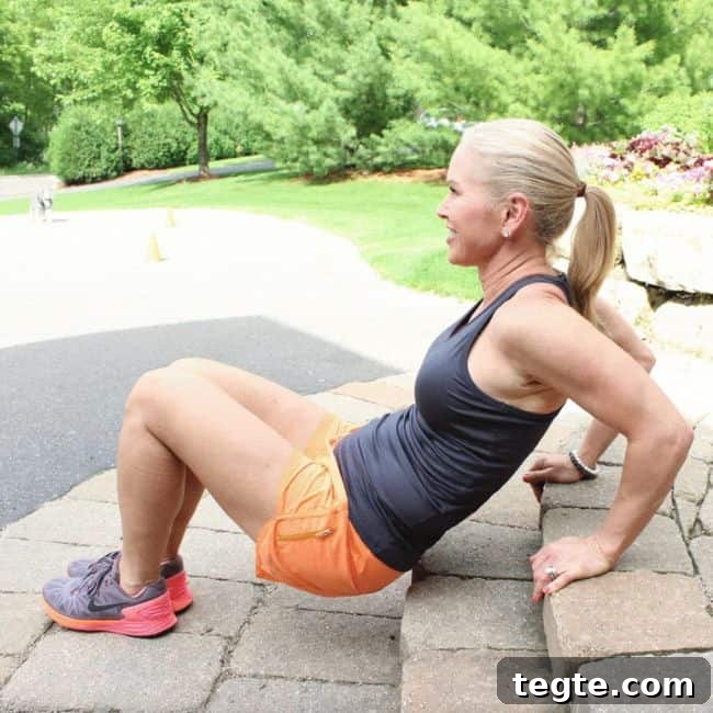 Outdoor Driveway Cardio and Strength Circuit for Women 8 Woman exercising on outdoor steps, smiling.
