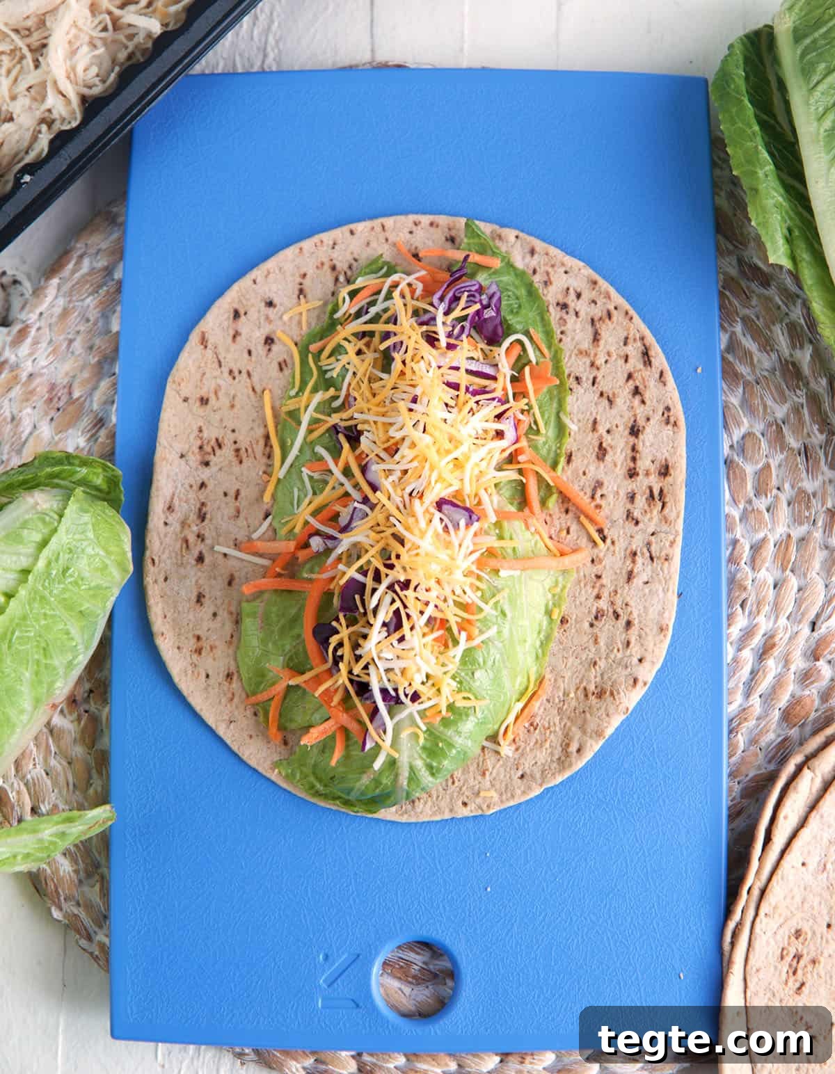 Chick-fil-A Cool Wrap: Chicken & Fresh Veggie Wrap Review 4 Overhead view of ingredients for Chick-fil-A Cool Wrap layered onto tortilla