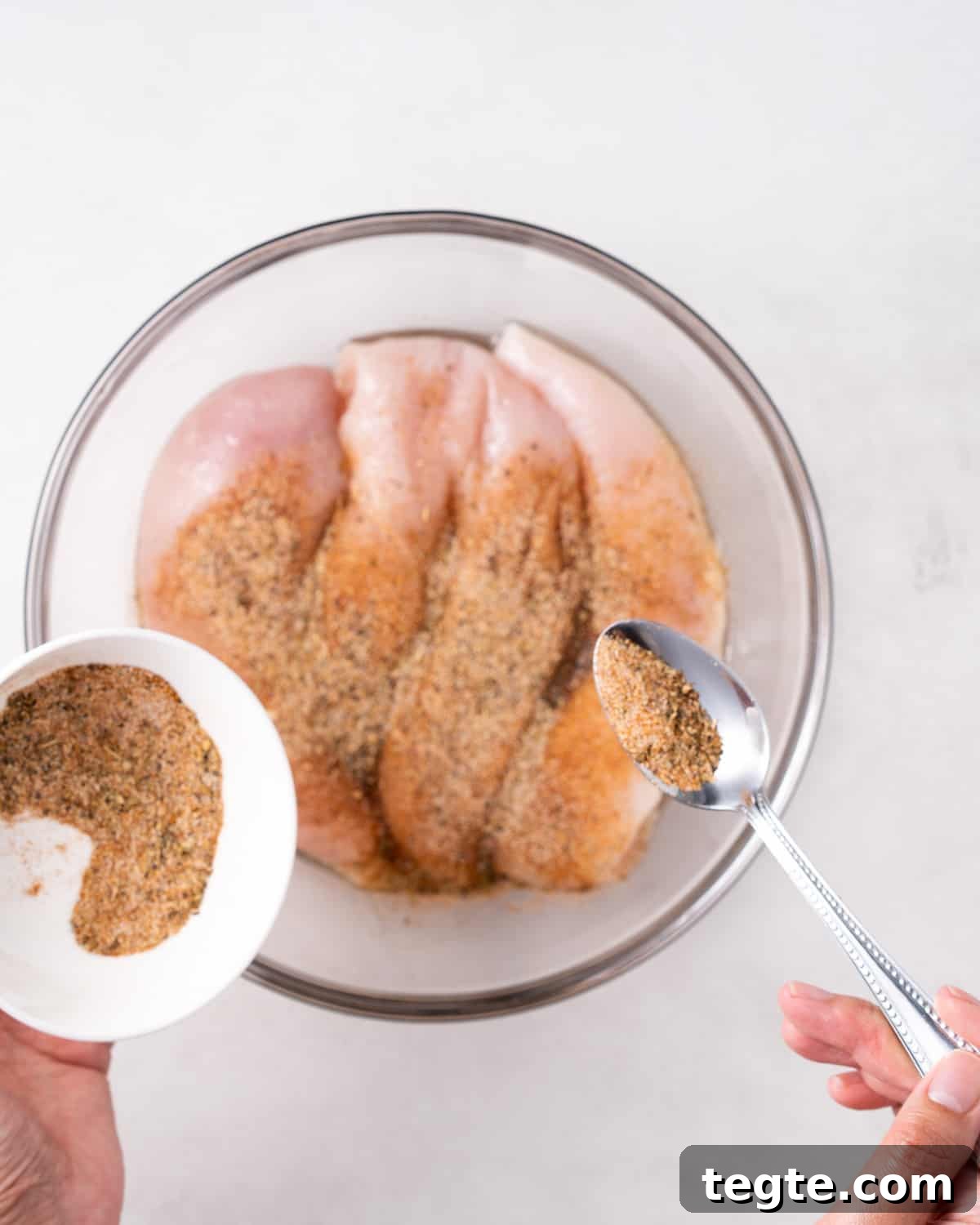 Crispy Juicy Air Fryer Chicken Breast Recipe in 20 Minutes 5 seasoning chicken breasts with garlic powder, onion powder, paprika, salt, pepper and oregano seasoning.