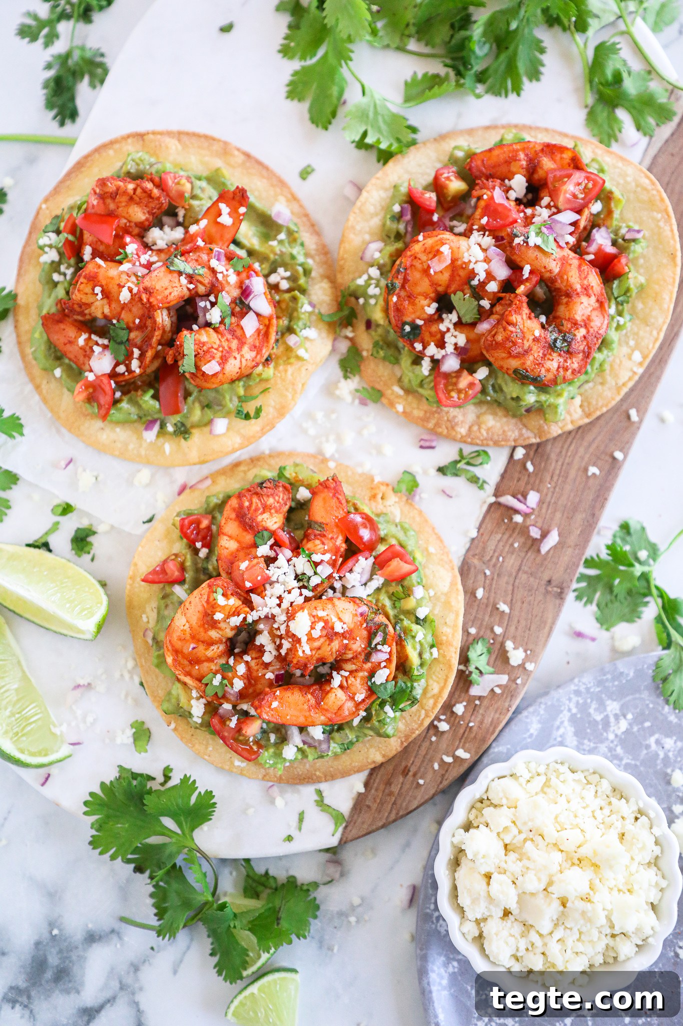 Spicy Shrimp Tostadas with Creamy Guacamole 5 Spicy shrimp and creamy guacamole are served on top of a crispy tostada shell with all the taco fixings! This is one easy meal you won't get enough of!