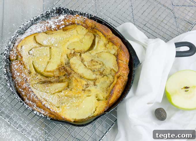 Caramel Apple Dutch Baby in a cast iron skillet