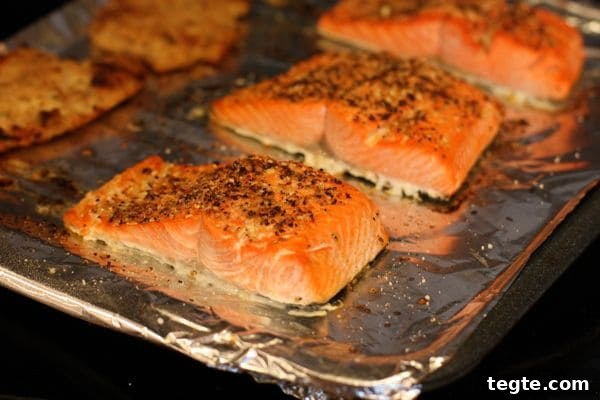 Healthy Broiled Salmon Gyros salmon covered in seasonings on a baking sheet covered with aluminum foil
