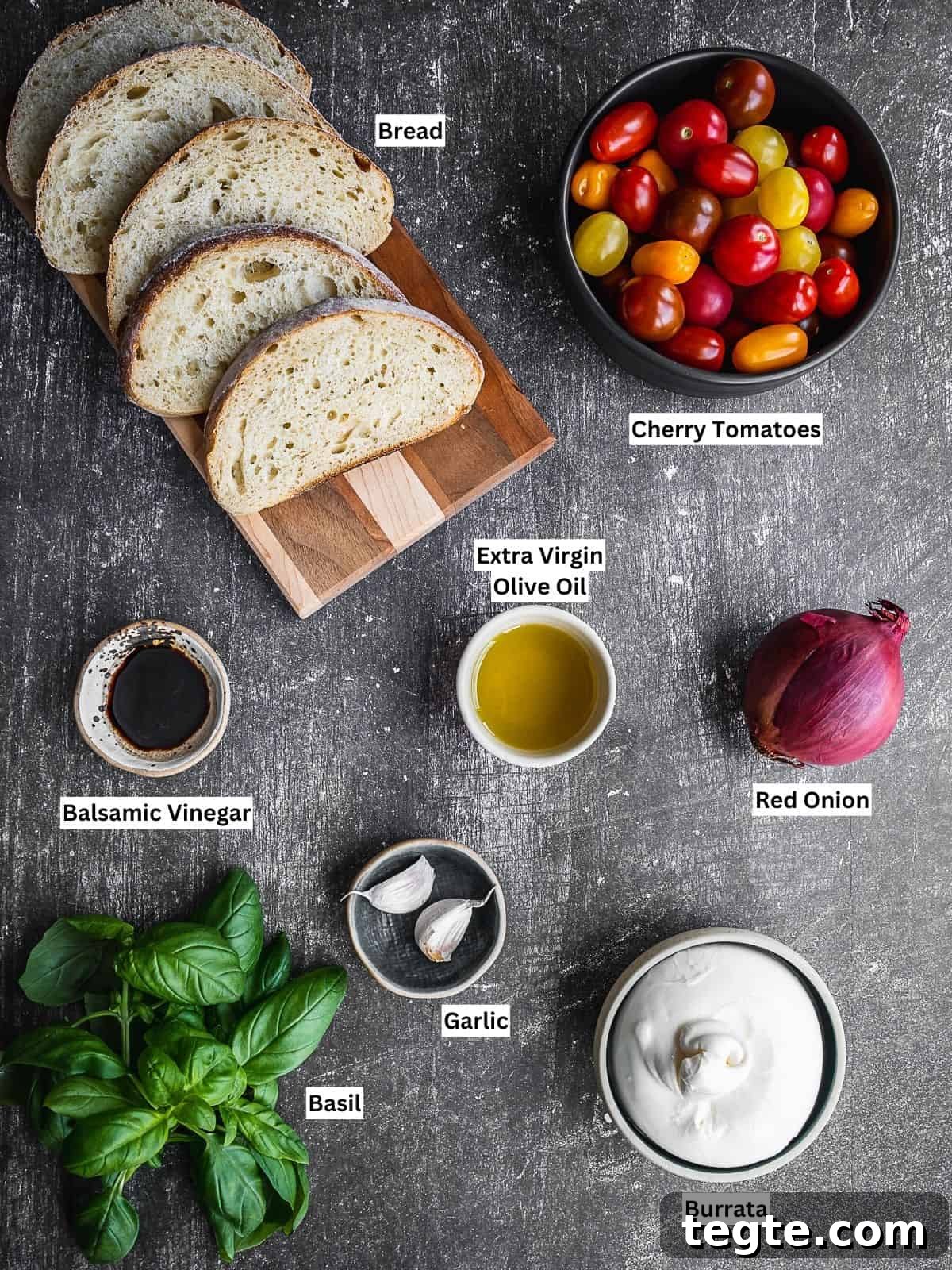 Creamy Burrata Bruschetta with Heirloom Tomatoes and Basil 4 Burrata bruschetta recipe ingredients on a board.