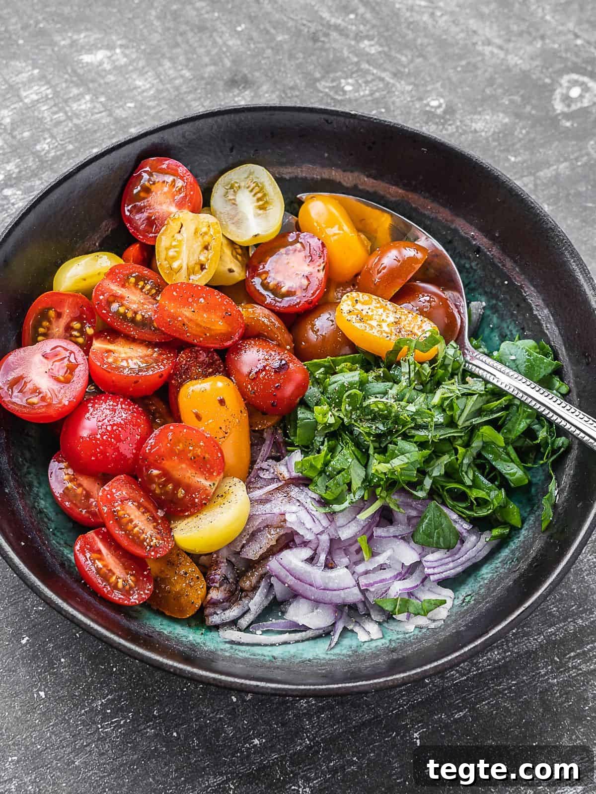 Creamy Burrata Bruschetta with Heirloom Tomatoes and Basil 6 A bowl with cherry tomatoes, basil and sliced onions.