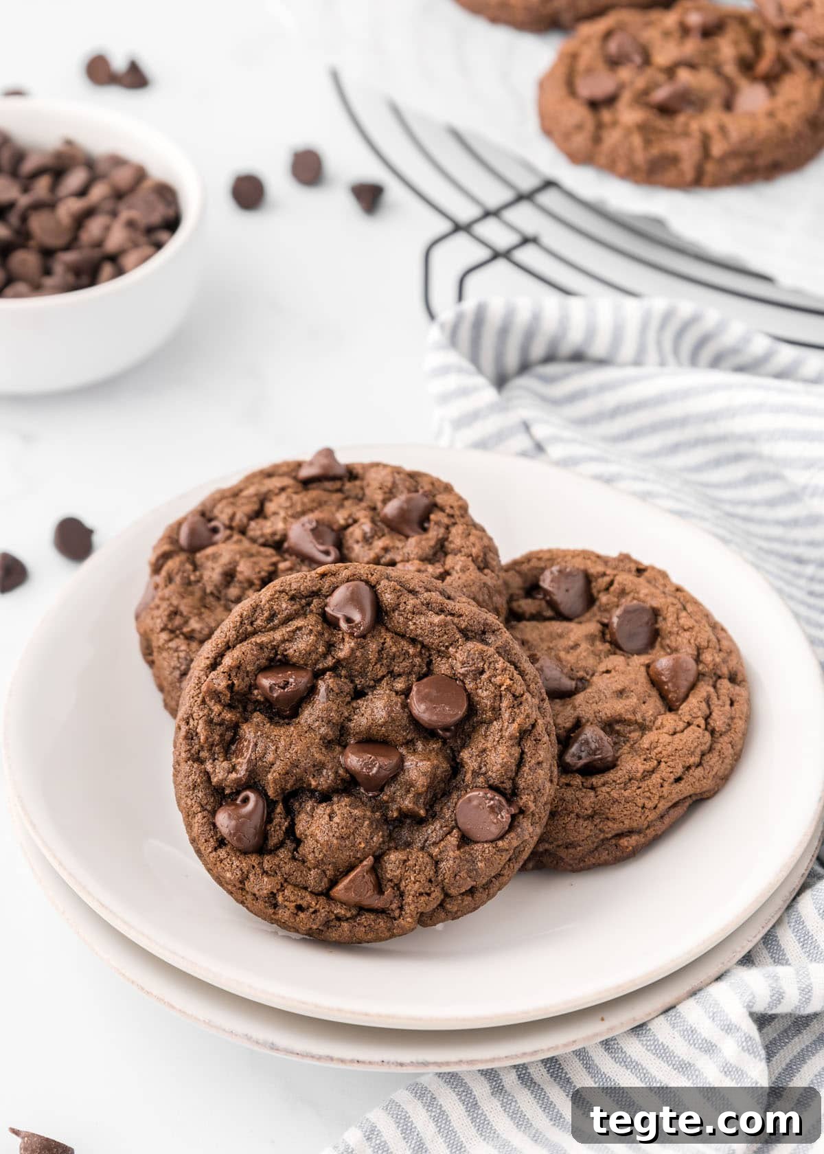 Ultimate Double Chocolate Cookies Recipe: Moist, Fudgy Bites 2 Three double chocolate chip cookies on a white plate.