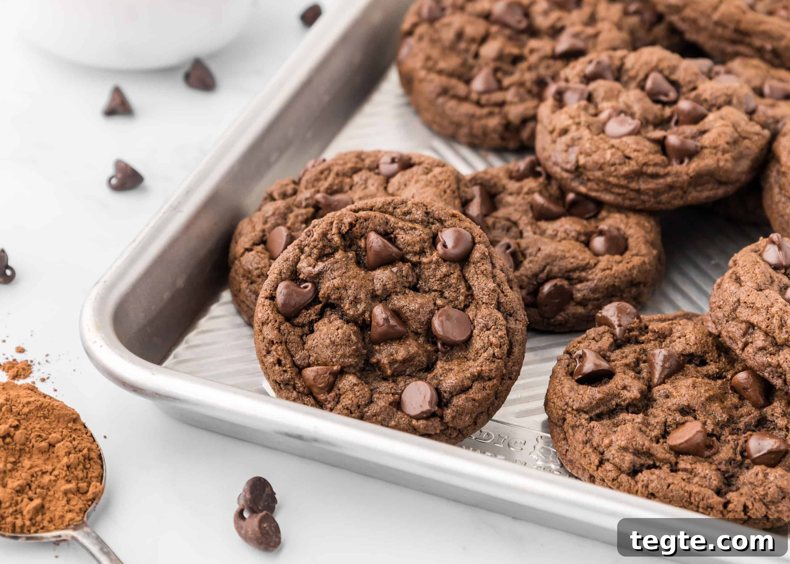 Ultimate Double Chocolate Cookies Recipe: Moist, Fudgy Bites 4 Double chocolate chip cookies on a baking sheet.