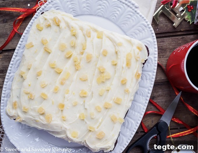 Molasses Gingerbread Cake with Cream Cheese Frosting 2 Gingerbread cake topped with cream cheese frosting and crystallized ginger.